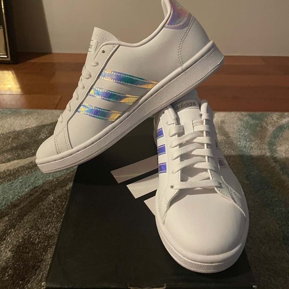 New white adidas size 7 sneaker with with light blue on stripes